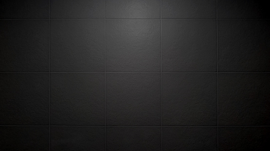 slate tile ceramic for industrial interior decoration style. close up dark black square tile pattern with light from above used as background. large rustic bathroom tile pattern.
