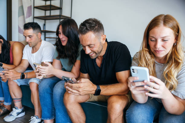 istock Friends sitting and texting on a couch on mobile during relocation 1475921876