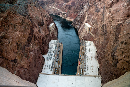 The Hoover Dam towers above the Colorado River, a marvel of engineering and a testament to human ingenuity. Built during the Great Depression, the dam provided thousands of jobs and transformed the arid landscape of the American Southwest, generating hydroelectric power and providing water for irrigation and drinking. The massive concrete structure spans the Black Canyon, holding back the mighty Colorado River and creating the vast Lake Mead. Visitors can take guided tours of the dam's interior, marveling at the complex machinery and learning about the history of this iconic landmark. The Hoover Dam stands as a symbol of American resilience and resourcefulness, a testament to the power of human cooperation and determination.