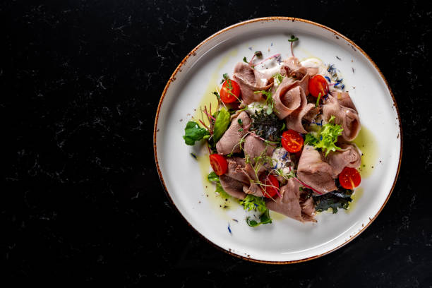 istock Beef tongue salad with fresh vegetables in plate 1475932334