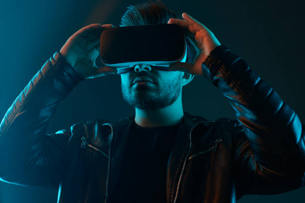 istock Man in VR glasses in dark studio 1475933335