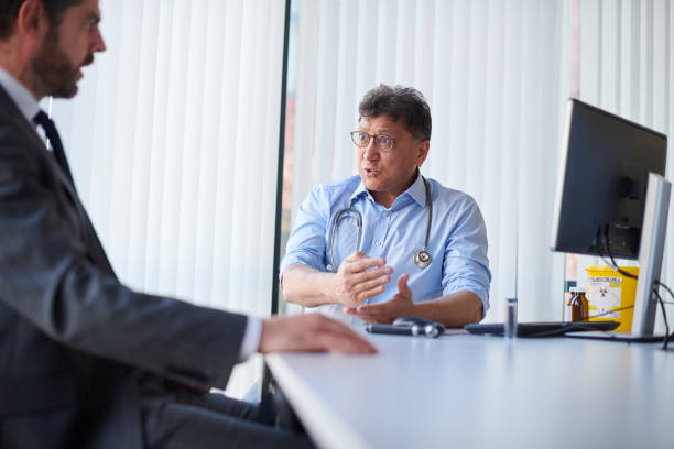 istock senior doctor chatting to laywer 1475940722
