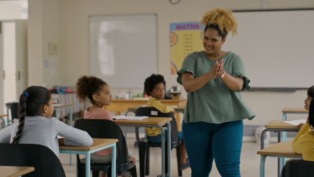 Teacher high five children in classroom for learning success, education and teaching, congratulations and clapping. Happy black woman with clever, smart kindergarten kids support and celebrate goals