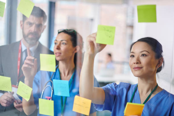 istock medical team brainstorming with administrator 1475945639