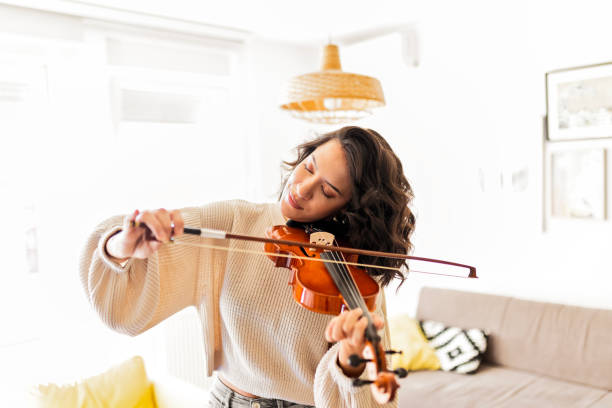 istock Young violinist practicing at home enjoying playing instrument 1475951973