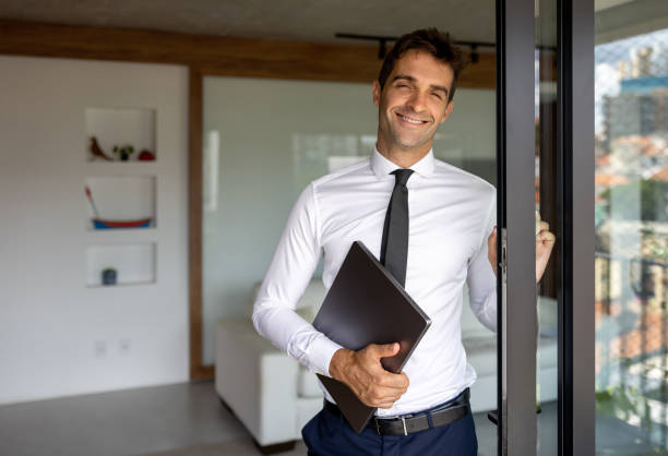 istock Happy real estate agent showing a house 1475954308