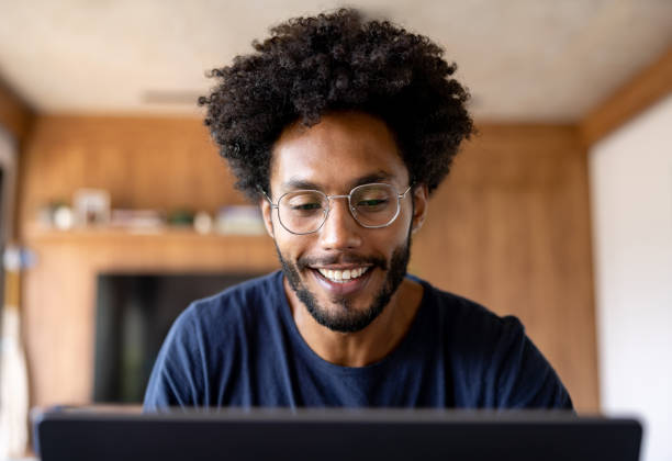 istock Happy man working at home and writing on his laptop 1475954372