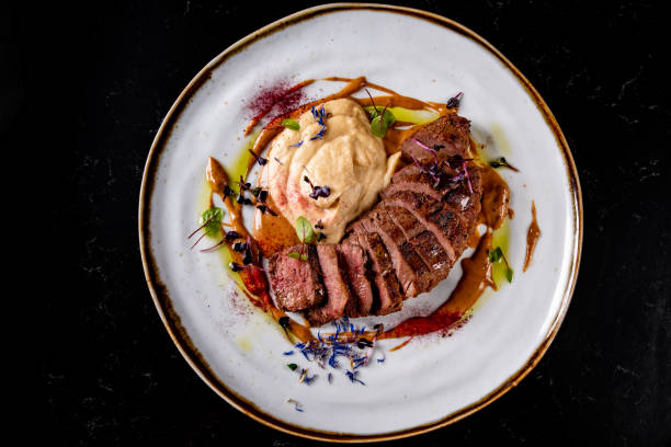 istock Roasted Duck breast fillets with vegetable pure in plate 1475955550