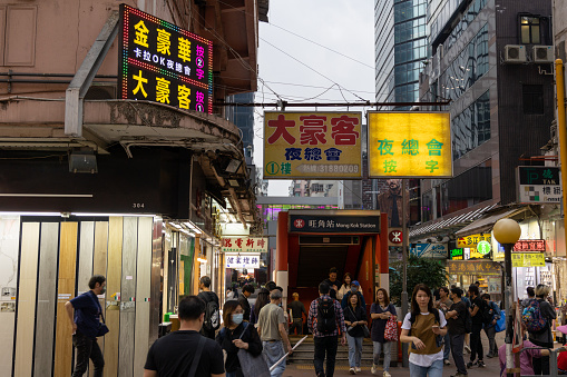 Hong Kong - March 24, 2023 : Pedestrians walk past the signboards for night club in Mong Kok, Kowloon, Hong Kong.