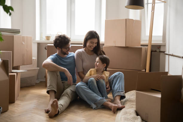 istock Cheerful parents and cute daughter kid sitting on heating floor 1475969968