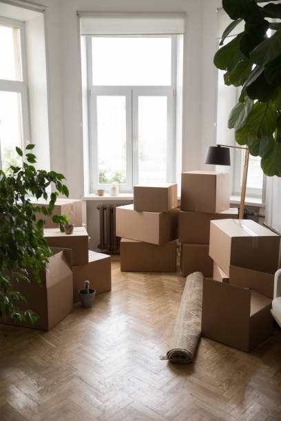 Stacks of cardboard boxes packed for moving, transportation stock photo