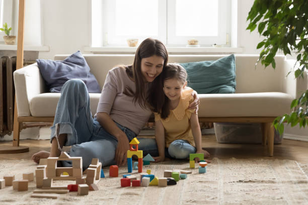istock Cheerful young mom enjoying playtime with kid at home 1475969983