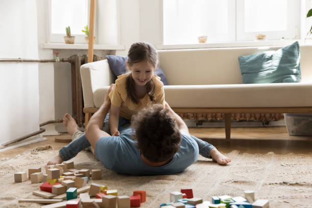 istock Playful sweet daughter kid resting dads chest, laughing 1475970005