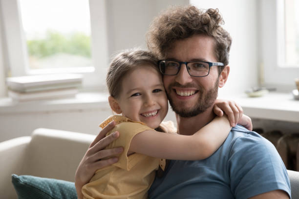 istock Positive father hugging little kid girl hugging with face touch 1475970027