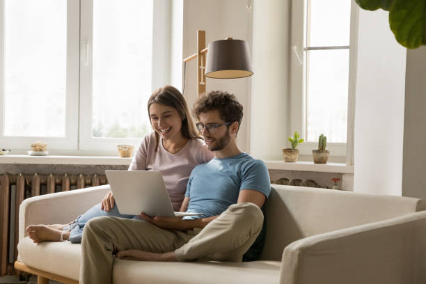 istock Happy focused young attractive couple speaking on video call 1475970041