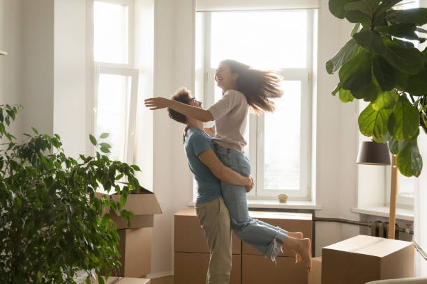 istock Happy excited young couple celebrating relocation, buying flat 1475970057