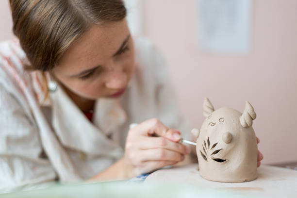 istock Girl making cute pottery animal 1475971417