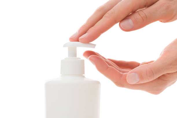 istock Young adult woman hands using moisturizing cream from plastic pump bottle isolated on white background. Care about clean, soft and smooth body skin. Closeup. Side view. Daily beauty product. 1475982152