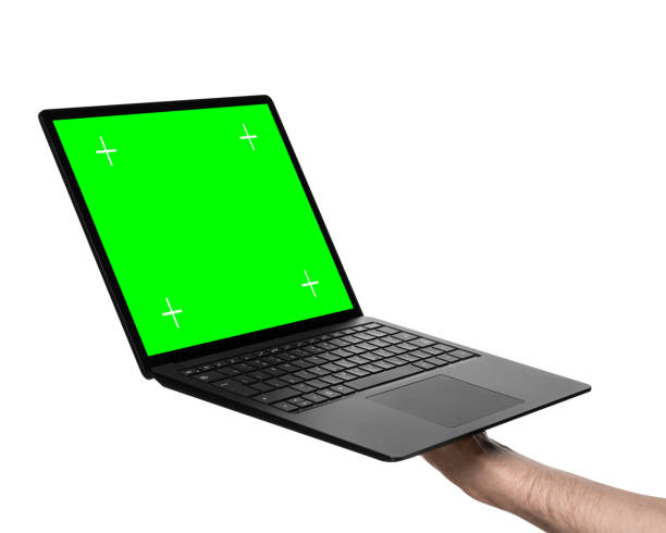 Male hand holding laptop with green screen stock photo