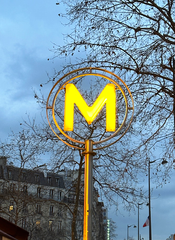 Close-up of Metro sign in Paris by early evening