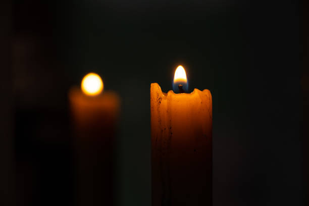 istock candle fire and back reflection of a candle in a mirror in the dark 1475986699