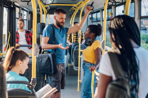 istock Multiracial friends talking while riding a bus in the city 1475989544