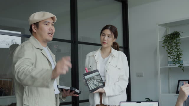 Asian man and woman presenting solar panel products They're selling  technology gadget about renewable energy.