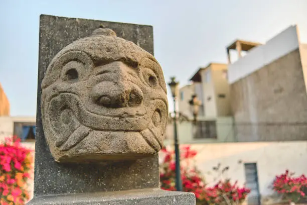 Photo of Chavin de Huantar, Peru. shows the nailed head, representation carved in stone, pre incan culture