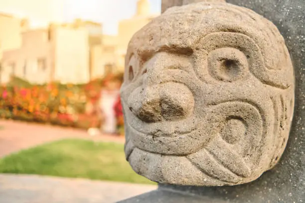Photo of Chavin de Huantar, Peru. shows the nailed head, representation carved in stone, pre incan culture