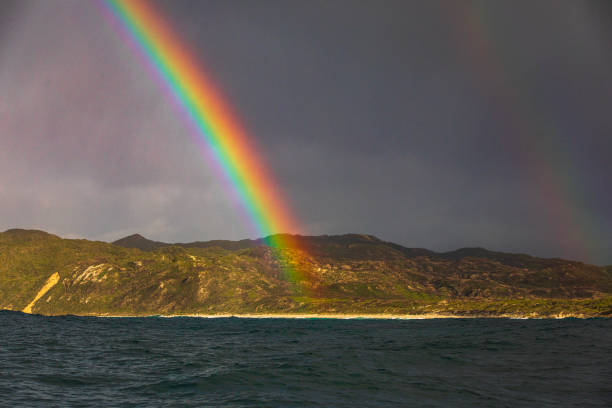 istock Bright colourful rainbow during a storm in the ocean 1475992804