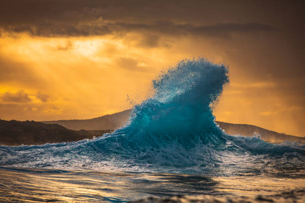 istock Wave explosion in the ocean on a stormy morning with golden light 1475992896