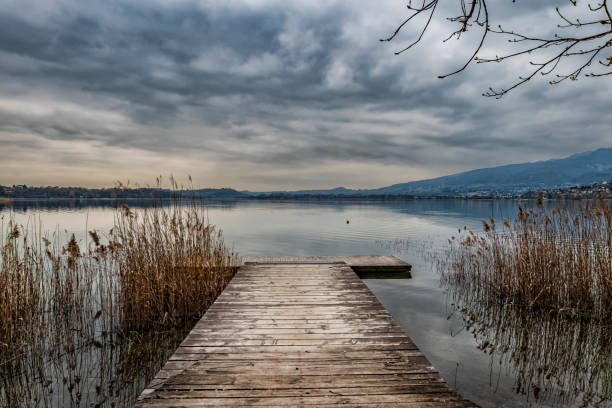 Wood catwalk on Lake Pusiano Wood catwalk on Lake Pusiano floating platform stock pictures, royalty-free photos & images