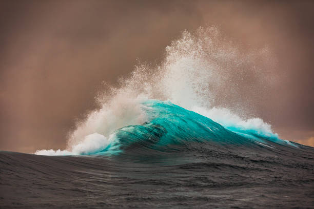 istock Wave explosion in the ocean on a stormy morning with golden light 1475992918