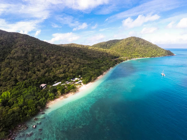 Tropical beach island paradise with sailing yacht moored. Queensland