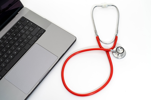 A laptop computer keyboard and a stethoscope - white background