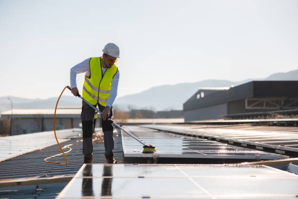 istock Young worker cleaning solar panels on a sunny day 1475997154