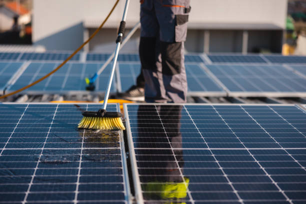 istock Close-up of workers cleaning solar panels on a rooftop 1475997197