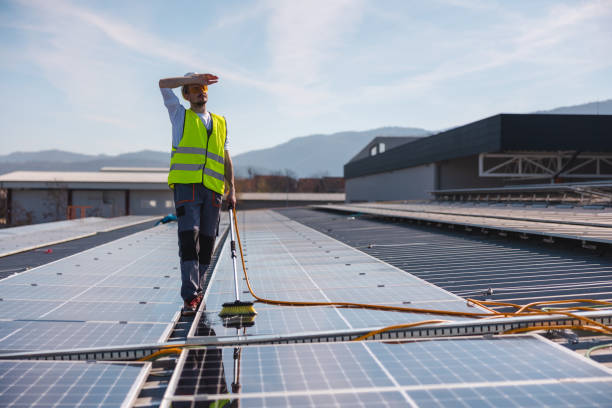 istock Young male worker taking a break from cleaning solar panels 1475997938