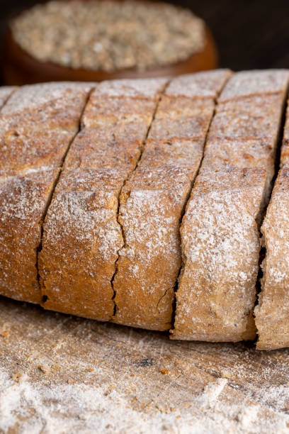 istock Cut into pieces fresh baked loaf of dark bread 1476000301