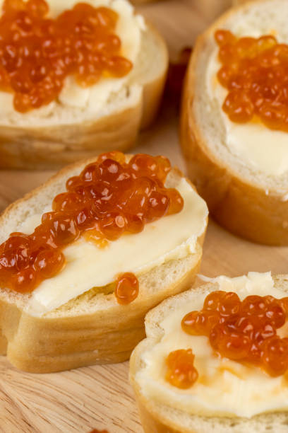 istock Thinly sliced baguette with salmon caviar and butter 1476000311