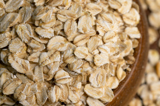 istock Oat flakes scattered on a wooden surface 1476000348