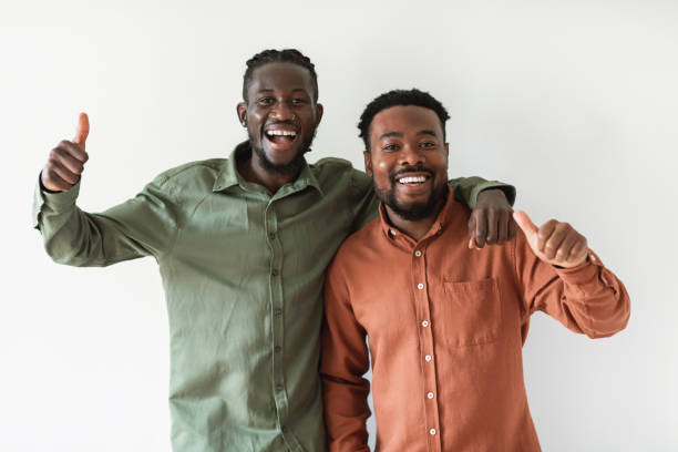 istock Two Cheerful African American Guys Gesturing Thumbs Up, White Background 1476000681