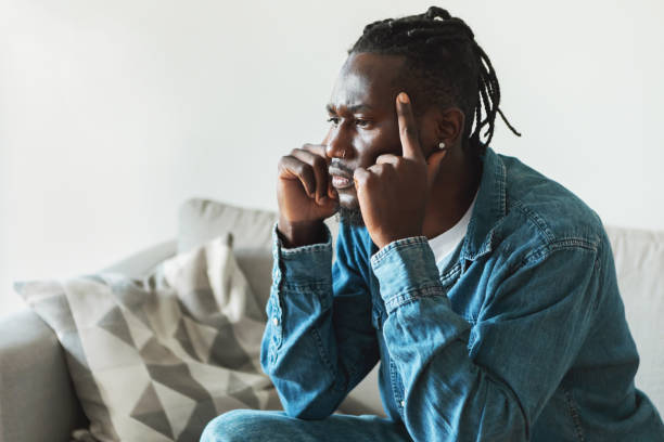 istock Thoughtful African American Man Thinking Touching Temples Sitting At Home 1476000692