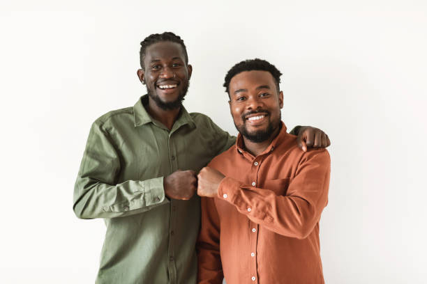 istock Two Happy African American Guys Bumping Fists Over White Background 1476000705