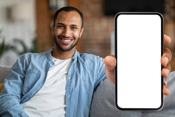 istock Place For Ad. Cheerful Black Man Demonstrating Blank Smartphone With White Screen 1476001409
