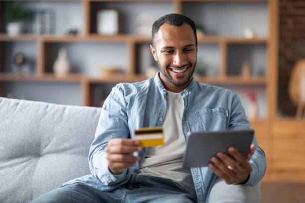 istock Online Payments. Handsome Black Young Man Using Digital Tablet And Credit Card 1476002023