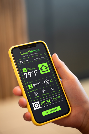 Smart home app. Teenage boy with iphone.