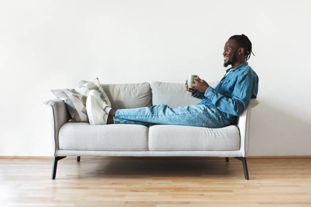 istock African American Man Drinking Coffee Holding Cup Sitting At Home 1476002349