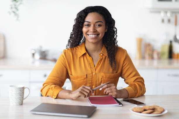 istock Happy black woman freelancer having coffee break, working from home 1476003819
