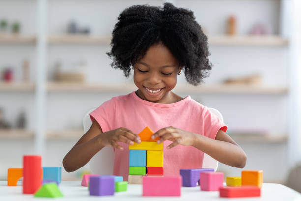 istock Little child playing with colorful wooden blocks 1476003955